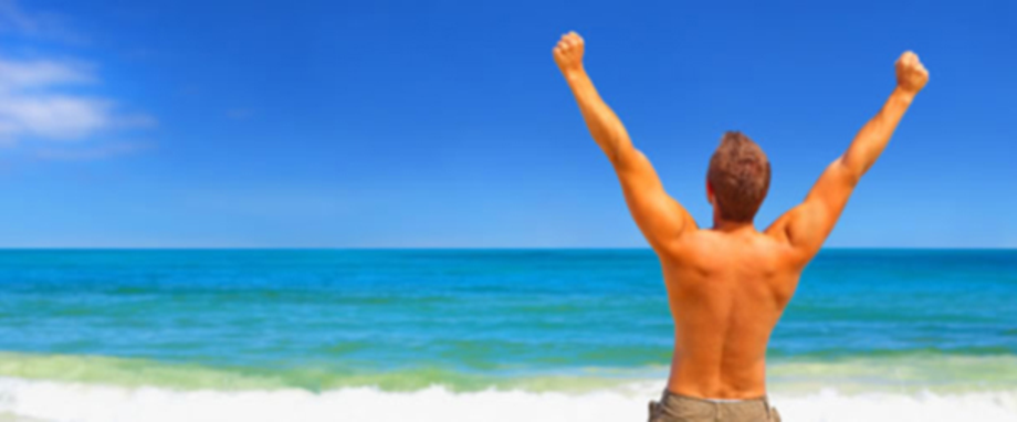 Person celebrating on a beach — wellness and health